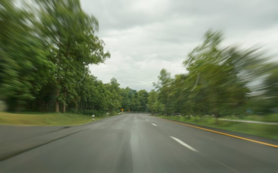 Blurred Road with Green Trees photo