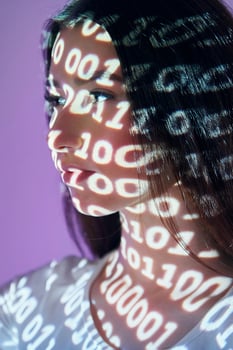 A woman with a face covered in binary code photo