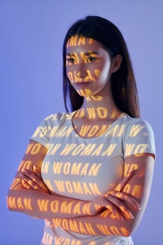 A woman with the words woman written on her arm photo