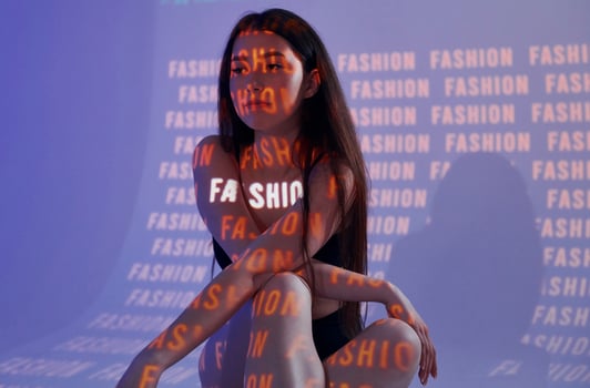 A woman sitting on a chair with the words fashion on it photo