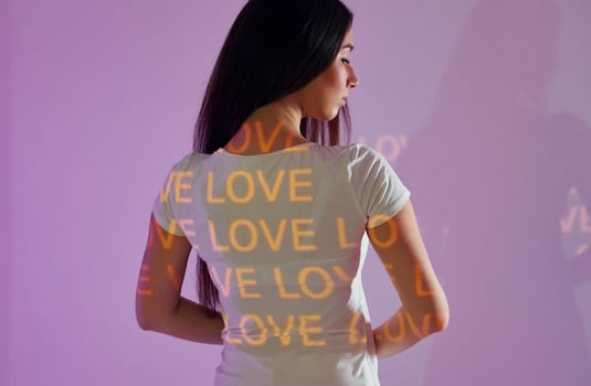 A woman wearing a shirt with the words love love love written on it photo