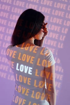 A woman wearing a t - shirt with the word love written on it photo