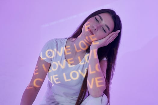 A woman sitting on a white chair with her eyes closed photo