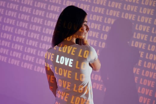 A woman wearing a white t - shirt with the word love written on it photo