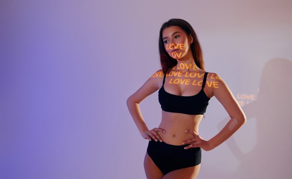 A woman in a black bra top and underwear photo