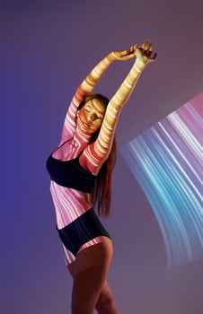 A woman in a swimsuit is holding her arms up photo