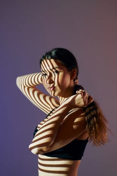 A woman in a bra top with her hair pulled back photo