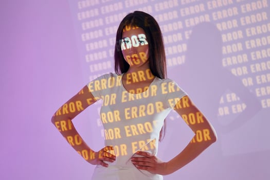 A woman standing in front of a wall with the words error. photo