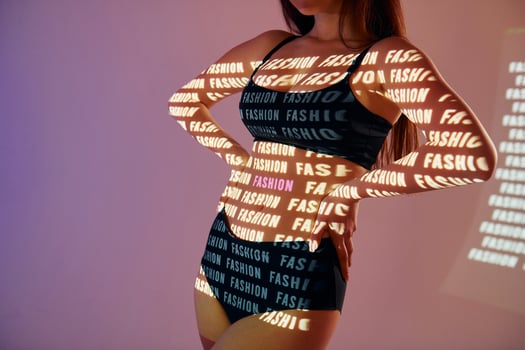 A woman in a black dress with the words fashion is fashion photo