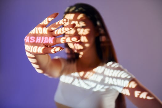 A woman holding up her hand with the word fashion written on it photo