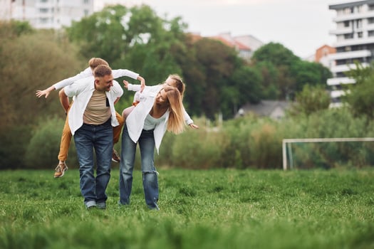 A family is playing in the grass photo