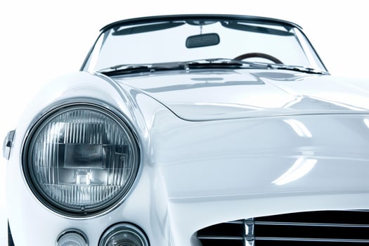 A classic white sports car with the hood up photo