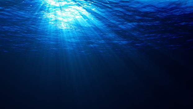 Underwater lights rays light beams penetrating the surface of water 8K photo