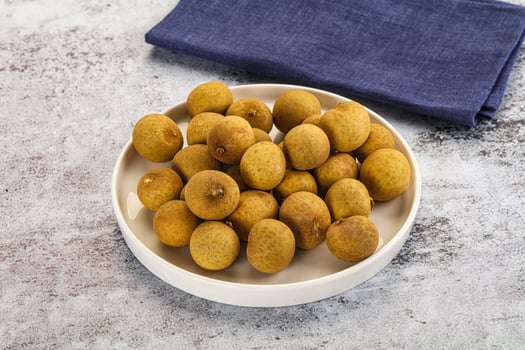 A bowl of kiwis on a table photo
