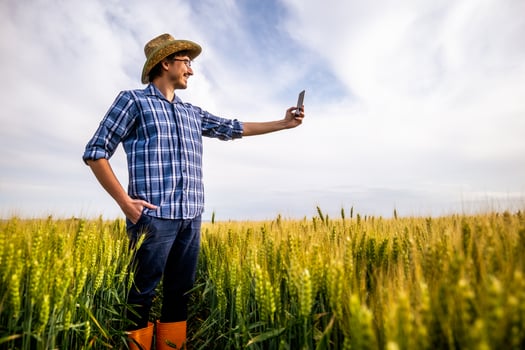 Portrait of agricultural worker in the growing wheat field. photo