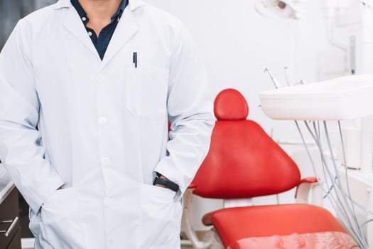 Unrecognizable adult man wearing white coat dentist or dentist on background a dental clinic. photo