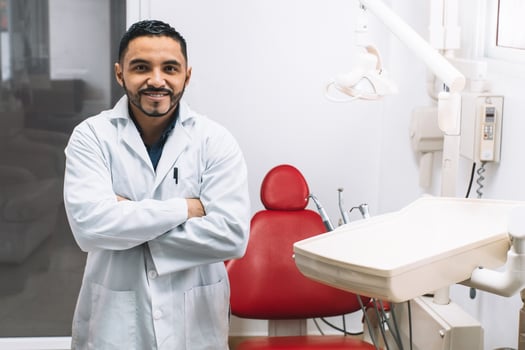 smiling Latin American adult man of dentistry profession in a clinic. photo