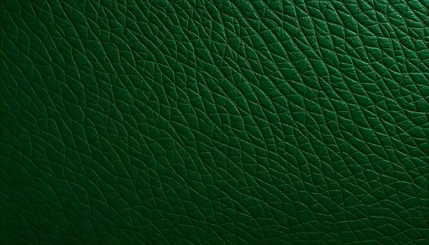 Textured synthetic leather background in a deep forest green, highlighting the natural wave like patterns and variations in surface texture photo