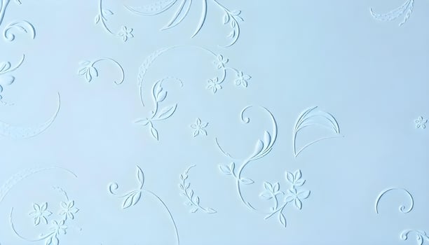 Vertical angle of a decorative plaster texture background in a soft pastel blue, with a slight sheen reflecting overhead light, showcasing smooth curves and delicate floral patterns photo