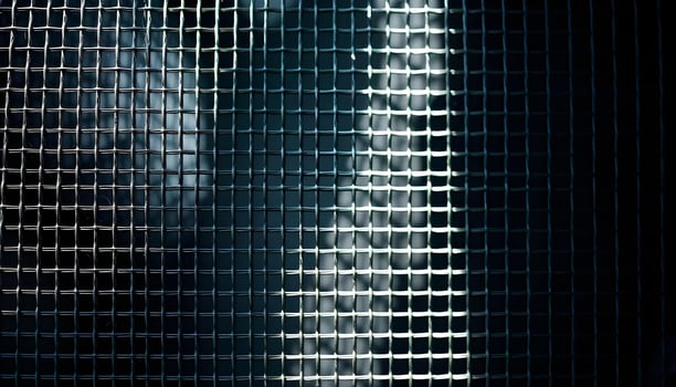 Close up of metal mesh texture, fine weave, light reflections, shadow play in dark corners photo