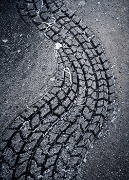 Tire tracks on asphalt road. Background and texture for design. Tire Tracks on Asphalt photo