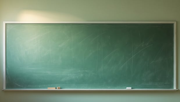 A green chalkboard is sitting on a white wall photo