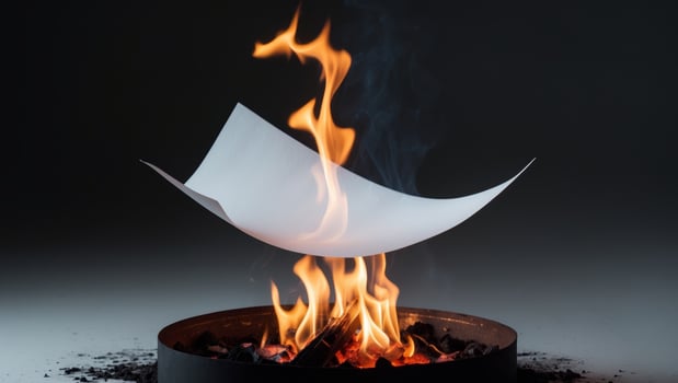 White piece of paper is in the middle of a fire. photo