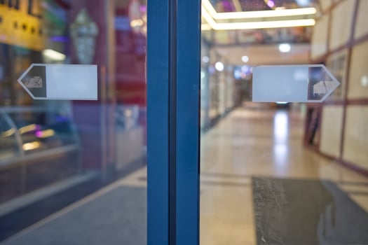 Glass Doors with Directional Arrows in Shopping Mall photo