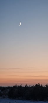 Beautiful pastel sunset with moon photo