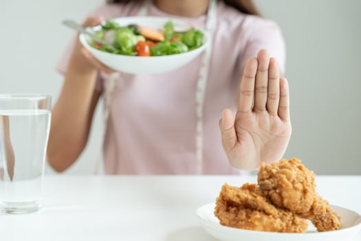 Beauty slim female body confuse fried chicken. Woman in restaurant achieves weight loss goal for healthy life, crazy about thinness, thin waist, nutritionist. Diet, body shape photo