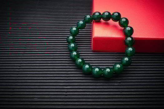 Jade bangle or bracelet on a black background. Close-up. photo