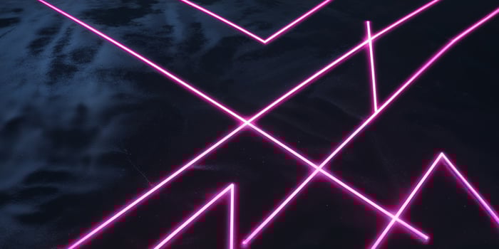 A pink neon sign with a cross on it photo