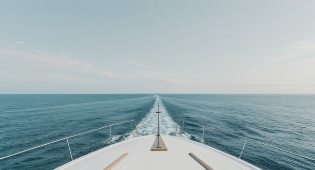 A view of the bow of a boat traveling across the ocean photo