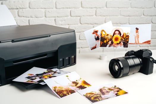 Printer and photo camera on table. Printing photos concept