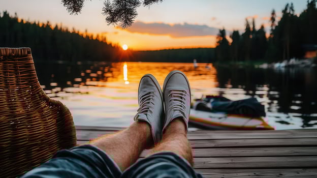 Relaxing Sunset View Person s Legs on Dock with White Sneakers Lake and Golden Hour photo