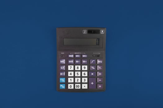 Top view of a calculator isolated on classic blue photo
