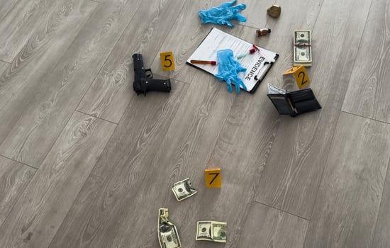 Crime scene, physical evidence. Gun handcuffs, money, dollar on a dark background. photo
