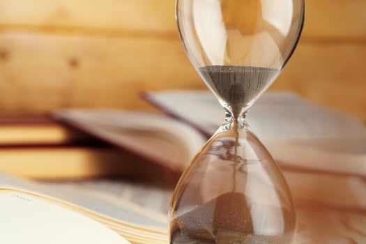Sandglass clock close up on a table photo