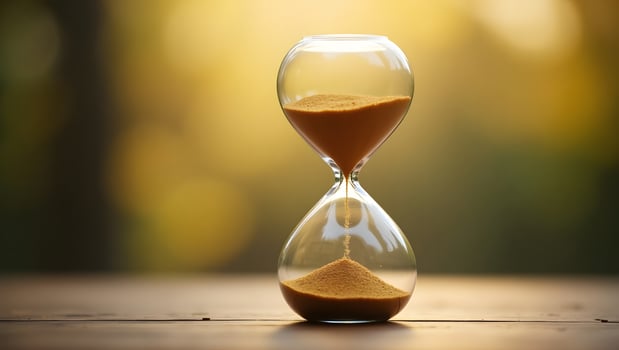 Elegant Hourglass with Flowing Sand in Warm Golden Light Concept of Time and Patience photo