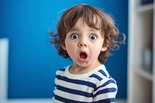 Portrait of a surprised little child. A little child looks at the camera with wide eyes in surprise photo