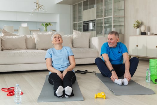 Fitness workout training. Senior adult mature healthy fit couple doing sports exercise on yoga mat on floor at home. Mid age old husband wife have training workout. Health care healthy lifestyle photo