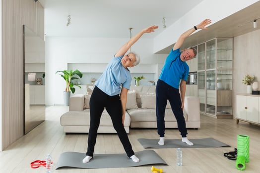 Fitness training. Senior mature healthy fit couple doing sports exercise at home. Mid age husband wife have training workout. Health care healthy lifestyle. Workout rehabilitation for old man woman photo