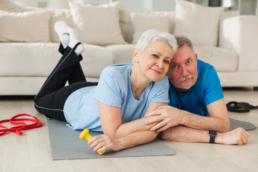 Fitness workout home training. Senior adult mature healthy fit couple resting after sports exercise on yoga mat at home. Mid age old husband wife have training workout. Health care healthy lifestyle photo