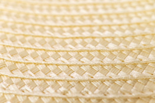 Close-up texture of woven straw material in soft light photo