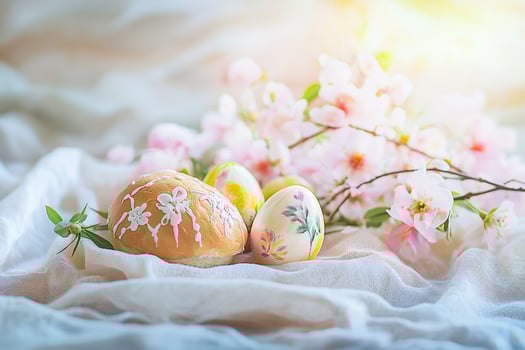 Easter eggs and flowers on textile background photo