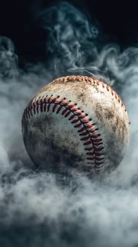 Baseball resting in a mysterious fog with a weathered surface showcasing signs of use and age photo