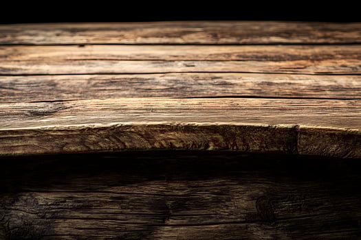 A wooden table with a bottle of wine on it photo