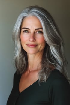 Beautiful mature woman with gray hair smiling serene and secure photo
