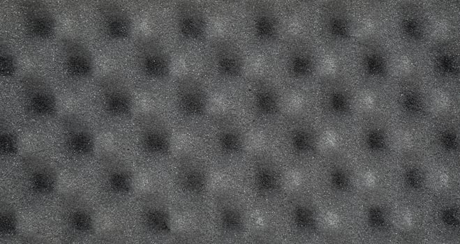 Acoustic foam panel in gray with an egg crate pattern, soundproofing material photo