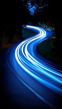 Blue Trails of Light. Long Exposure of a Winding Road at Night with Car Light Streaks, Motion Blur photo